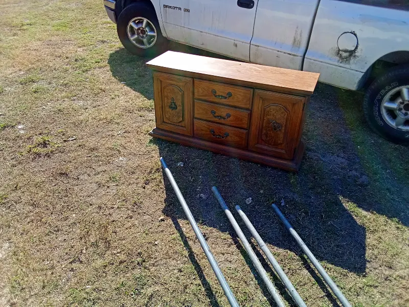 This solid wood minibar, bureau, or entertainment cabinet is a versatile storage piece with classic styling and plenty of usable space. It features two side cabinet doors, three center drawers, and a wide, flat top—perfect for use as a home bar, TV stand, buffet, or bedroom storage. The warm wood finish and traditional hardware give it a timeless look that fits well in living rooms, dining areas, bedrooms, or offices. The cabinet doors open to generous storage space, ideal for bottles, glassware, electronics, or household items. $50
