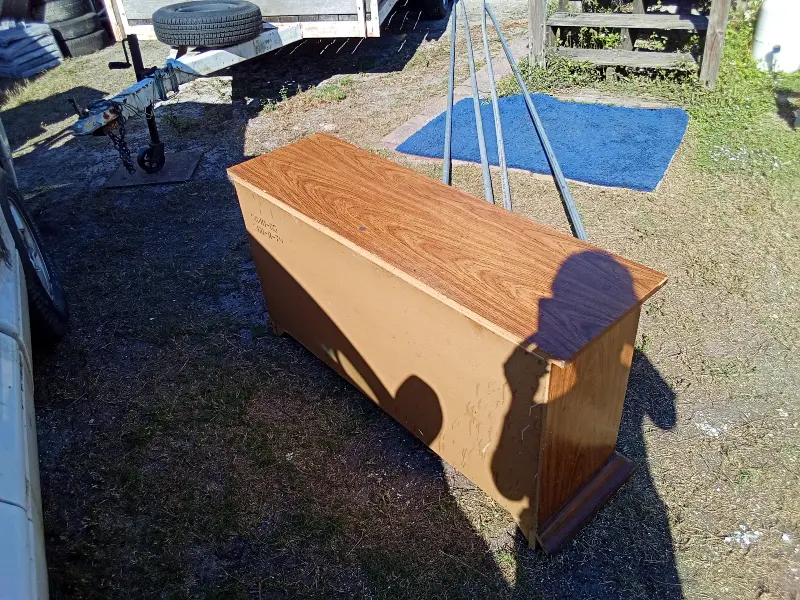 This solid wood minibar, bureau, or entertainment cabinet is a versatile storage piece with classic styling and plenty of usable space. It features two side cabinet doors, three center drawers, and a wide, flat top—perfect for use as a home bar, TV stand, buffet, or bedroom storage. The warm wood finish and traditional hardware give it a timeless look that fits well in living rooms, dining areas, bedrooms, or offices. The cabinet doors open to generous storage space, ideal for bottles, glassware, electronics, or household items. $50