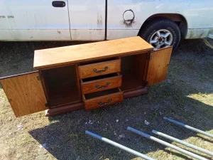 This solid wood minibar, bureau, or entertainment cabinet is a versatile storage piece with classic styling and plenty of usable space. It features two side cabinet doors, three center drawers, and a wide, flat top—perfect for use as a home bar, TV stand, buffet, or bedroom storage. The warm wood finish and traditional hardware give it a timeless look that fits well in living rooms, dining areas, bedrooms, or offices. The cabinet doors open to generous storage space, ideal for bottles, glassware, electronics, or household items. $50