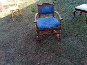 Ornate real wood accent chair with carved details and an antique-style design. Features a removable blue upholstered cushion for comfortable seating. Ideal as a statement chair for living rooms, bedrooms, offices, or entryways. Gently used. 💲 $40 donation requested